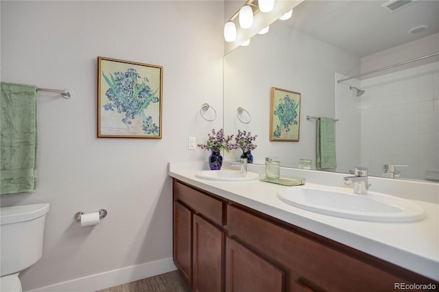 bathroom featuring toilet, vanity, hardwood / wood-style flooring, and walk in shower