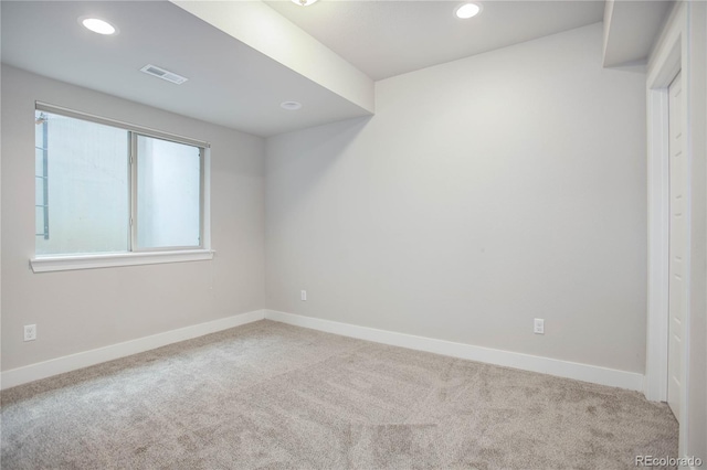 empty room featuring light colored carpet