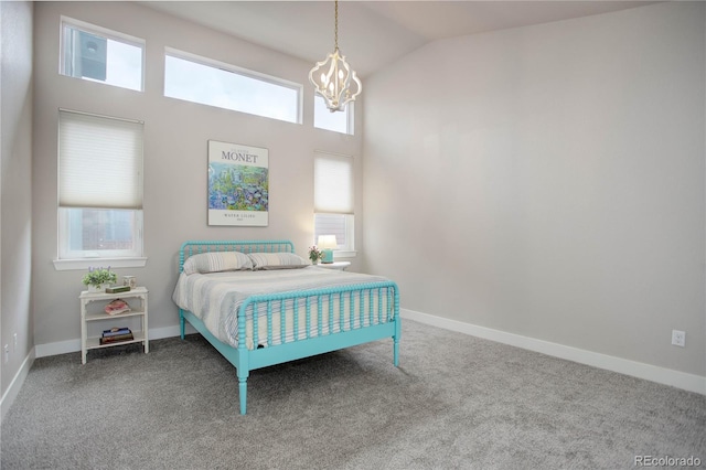 carpeted bedroom featuring multiple windows and vaulted ceiling