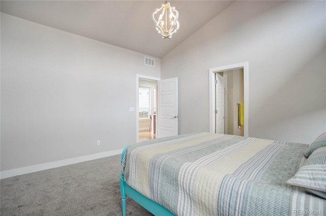 carpeted bedroom with a chandelier and high vaulted ceiling