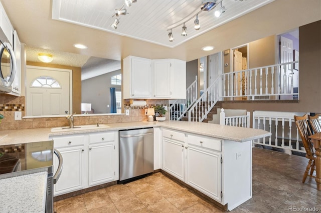 7598 Jared Way, Littleton, CO 80125 - kitchen with stainless steel appliances, a sink, decorative backsplash, and plenty of natural light