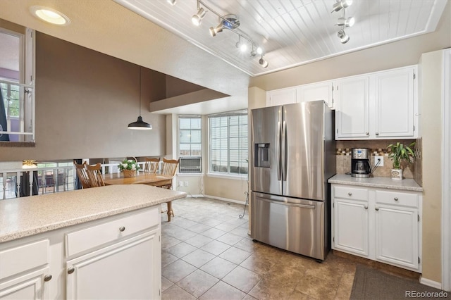 7598 Jared Way, Littleton, CO 80125 - kitchen featuring stainless steel fridge with ice dispenser, track lighting, white cabinets, light countertops, and healthy amount of natural light