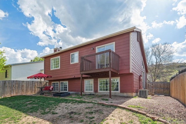 7598 Jared Way, Littleton, CO 80125 - back of property with central air condition unit, a fenced backyard, and a chimney