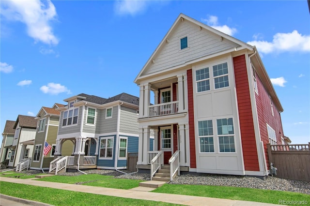 213 Washington St, Erie, CO 80516 - view of front of property with a balcony, fence, and covered porch