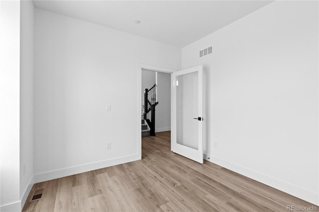 213 Washington St, Erie, CO 80516 - unfurnished room featuring stairs, light wood finished floors, and baseboards