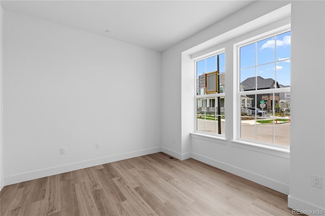 213 Washington St, Erie, CO 80516 - empty room with wood finished floors and baseboards