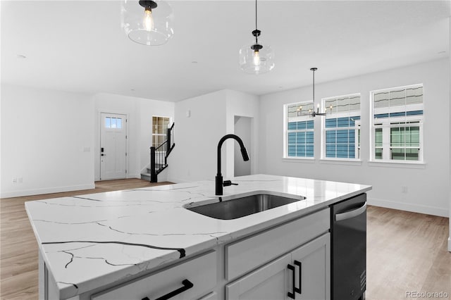 213 Washington St, Erie, CO 80516 - kitchen with a sink, dishwashing machine, light wood-style floors, and pendant lighting