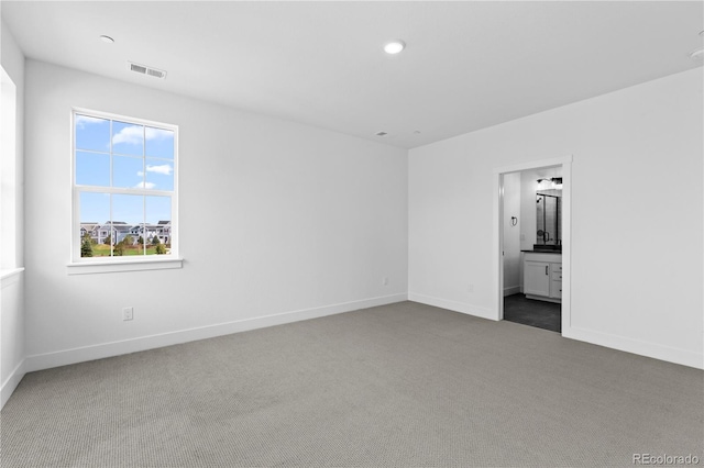 213 Washington St, Erie, CO 80516 - unfurnished bedroom featuring dark colored carpet, baseboards, connected bathroom, and recessed lighting