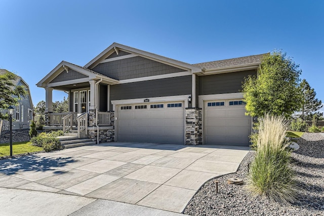 15919 Xanthia Way, Thornton, CO 80602 - view of front of property with concrete driveway, stone siding, a garage, and a porch