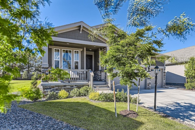 15919 Xanthia Way, Thornton, CO 80602 - view of front of house featuring driveway, a porch, a garage, and a front lawn