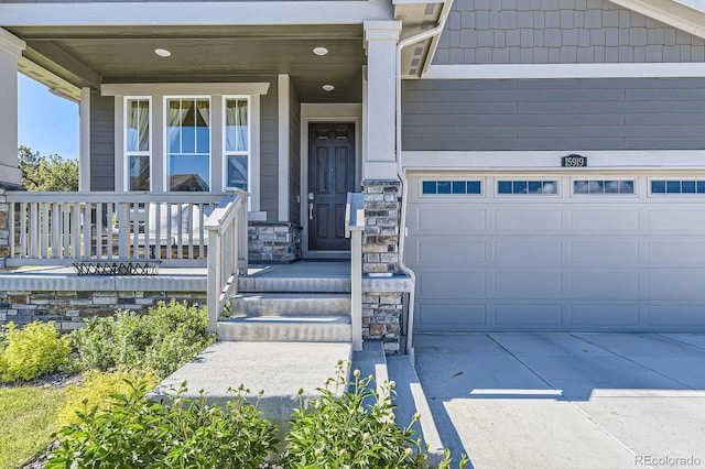 15919 Xanthia Way, Thornton, CO 80602 - doorway to property featuring stone siding, a garage, a porch, and concrete driveway