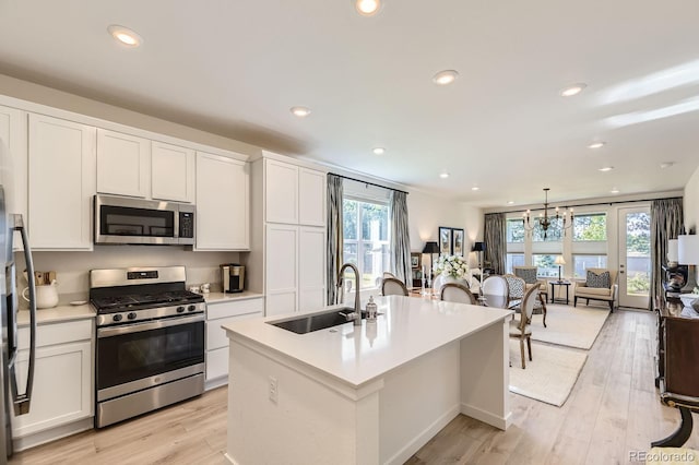 15919 Xanthia Way, Thornton, CO 80602 - kitchen with stainless steel appliances, a sink, light countertops, recessed lighting, and white cabinetry