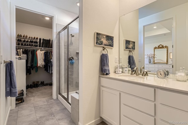 15919 Xanthia Way, Thornton, CO 80602 - bathroom with a spacious closet, a shower stall, vanity, and recessed lighting