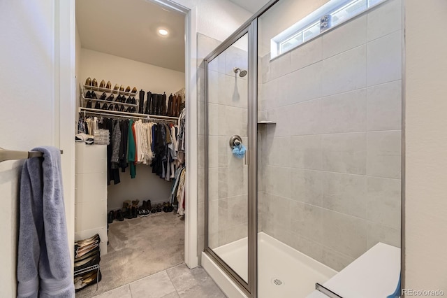 15919 Xanthia Way, Thornton, CO 80602 - bathroom featuring a stall shower, a walk in closet, tile patterned flooring, and recessed lighting