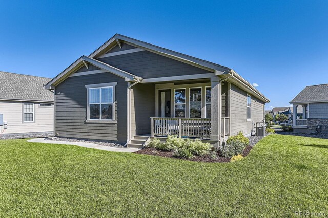 15919 Xanthia Way, Thornton, CO 80602 - view of front of home featuring covered porch, a front yard, and central AC