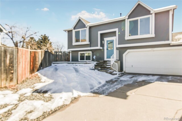 18971 E Mercer Dr, Aurora, CO 80013 - raised ranch with a garage, driveway, and stucco siding