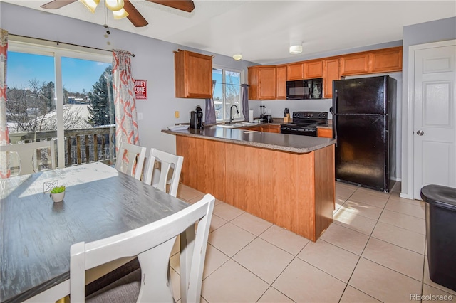 18971 E Mercer Dr, Aurora, CO 80013 - kitchen featuring black appliances, a ceiling fan, a sink, a peninsula, and brown cabinetry