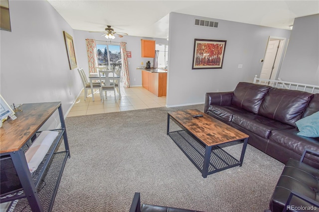 18971 E Mercer Dr, Aurora, CO 80013 - living room with ceiling fan, light tile patterned floors, baseboards, and light carpet