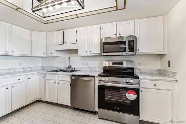 kitchen featuring white cabinetry, stainless steel appliances, and sink