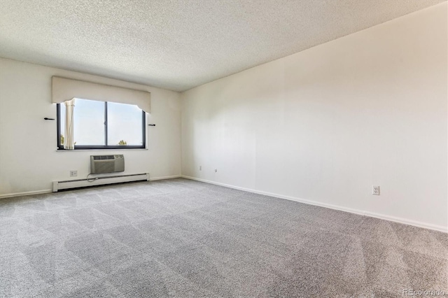 carpeted empty room with a baseboard heating unit, a textured ceiling, and a wall mounted air conditioner