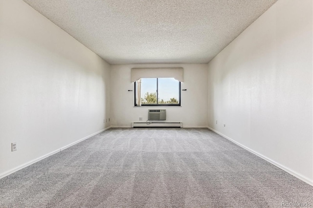 carpeted spare room featuring a textured ceiling and a baseboard radiator