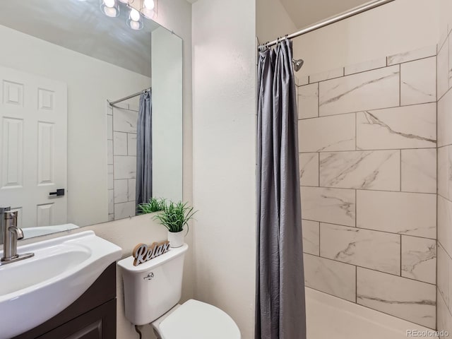 bathroom with toilet, curtained shower, and vanity