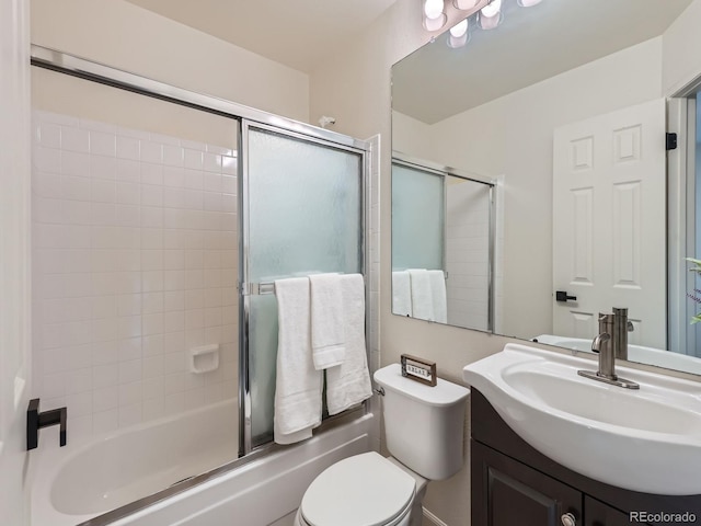 bathroom with shower / bath combination with glass door, vanity, and toilet