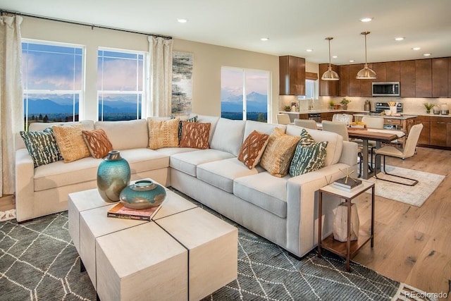 living room with dark wood-style floors and recessed lighting