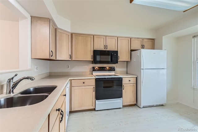 kitchen featuring white refrigerator, sink, light brown cabinets, and range with electric cooktop