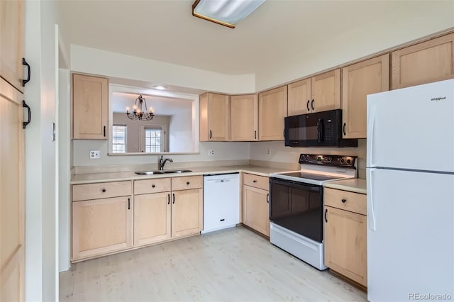 kitchen featuring sink, white appliances, light hardwood / wood-style flooring, and light brown cabinets