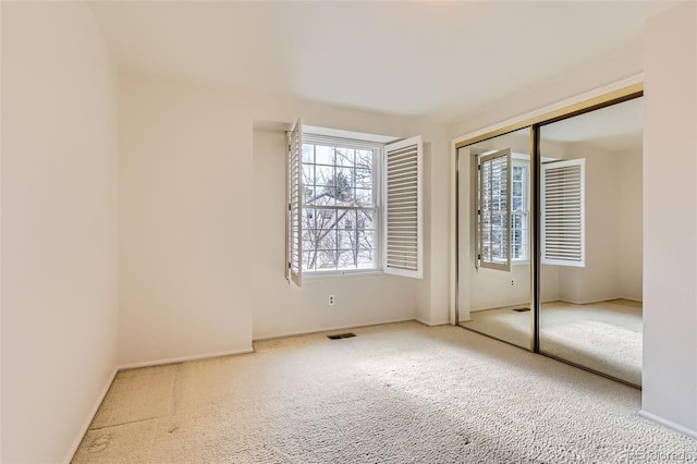 unfurnished bedroom with a closet and carpet