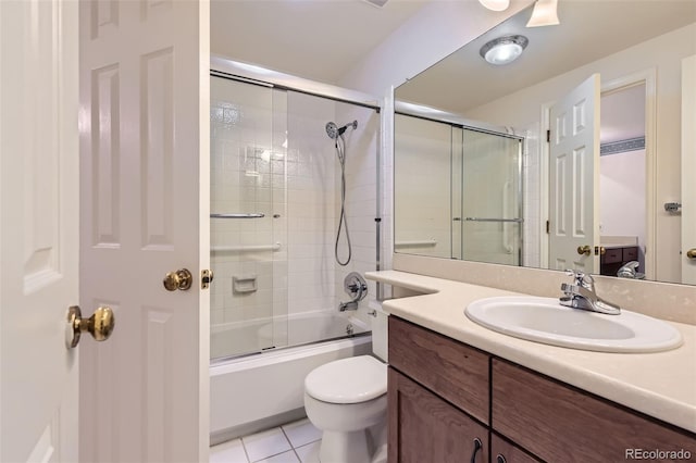 full bathroom with shower / bath combination with glass door, tile patterned floors, toilet, and vanity