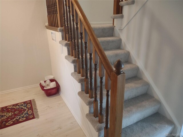 6712 E Briarwood Dr, Centennial, CO 80112 - stairs featuring wood finished floors and baseboards