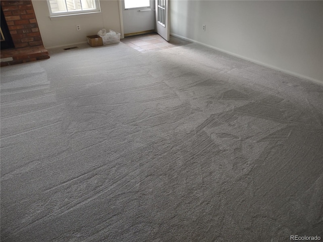 6712 E Briarwood Dr, Centennial, CO 80112 - carpeted spare room featuring a brick fireplace and baseboards