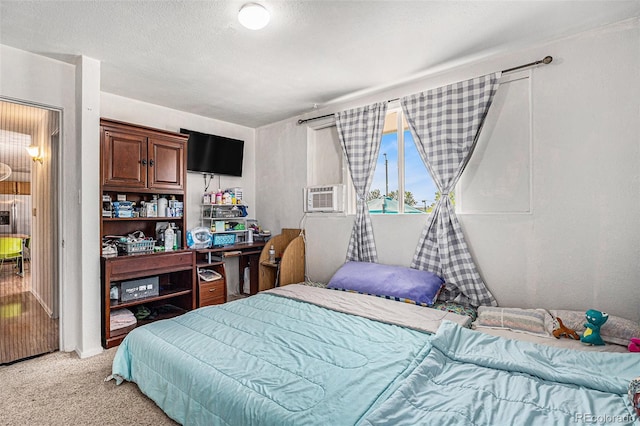 bedroom with cooling unit and light colored carpet