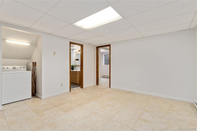 interior space featuring a baseboard heating unit, washer / clothes dryer, and a drop ceiling