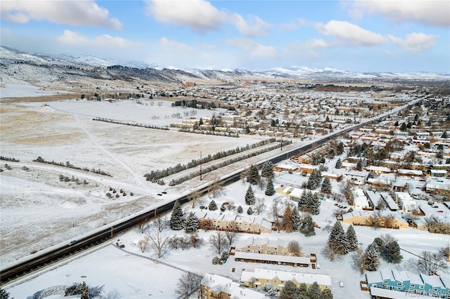 snowy aerial view with a mountain view