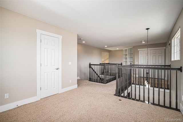 empty room featuring carpet flooring, recessed lighting, and baseboards