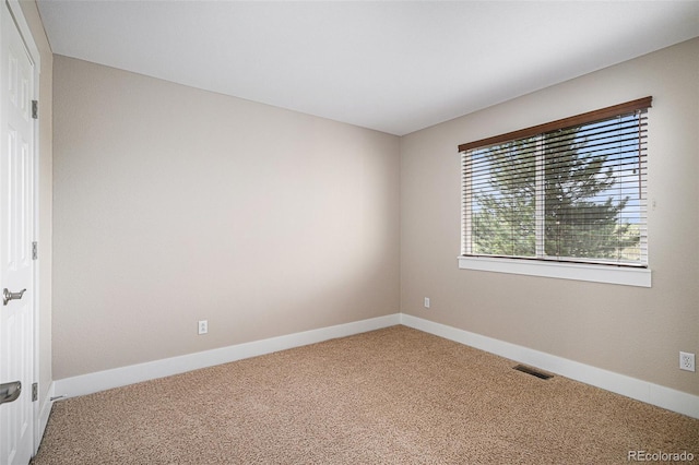 empty room with carpet and baseboards