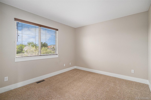 carpeted empty room with baseboards