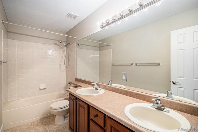 full bathroom featuring toilet, shower / bathtub combination, double vanity, and tile patterned flooring