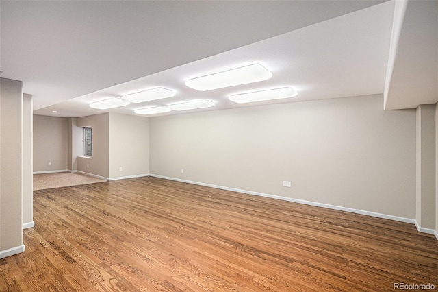 spare room with wood finished floors and baseboards