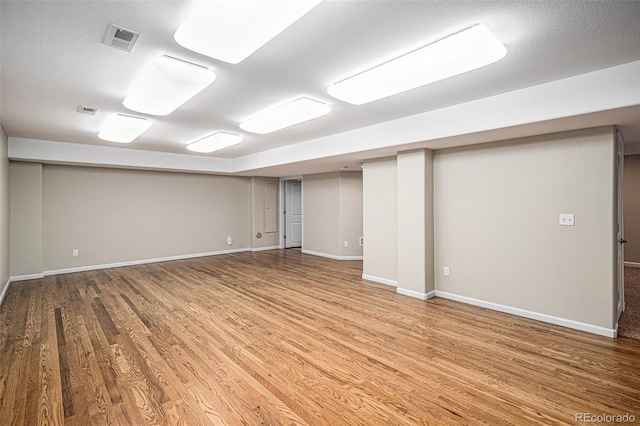 finished basement with wood finished floors and baseboards