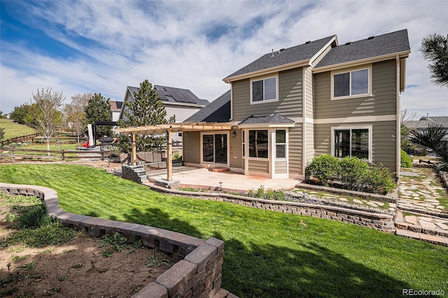 rear view of property featuring a pergola, a patio, and roof with shingles