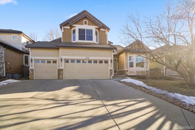 view of front of property with stone siding and concrete driveway