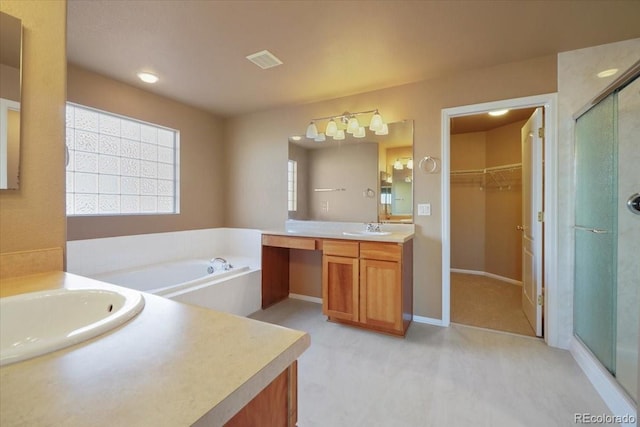 bathroom featuring a stall shower, visible vents, and a sink