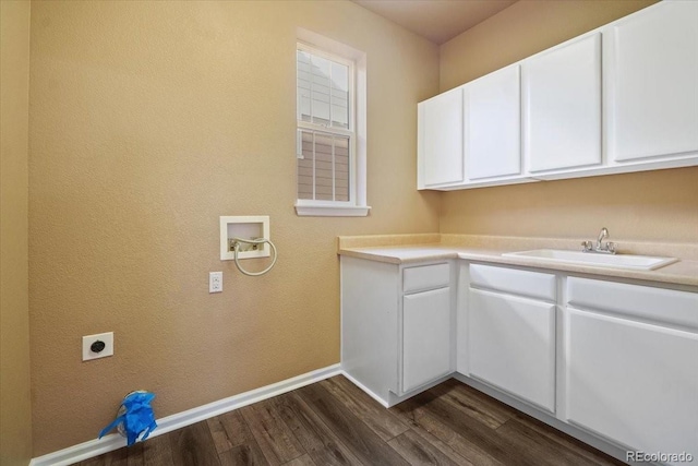 laundry room with cabinet space, dark wood finished floors, hookup for a washing machine, electric dryer hookup, and a sink