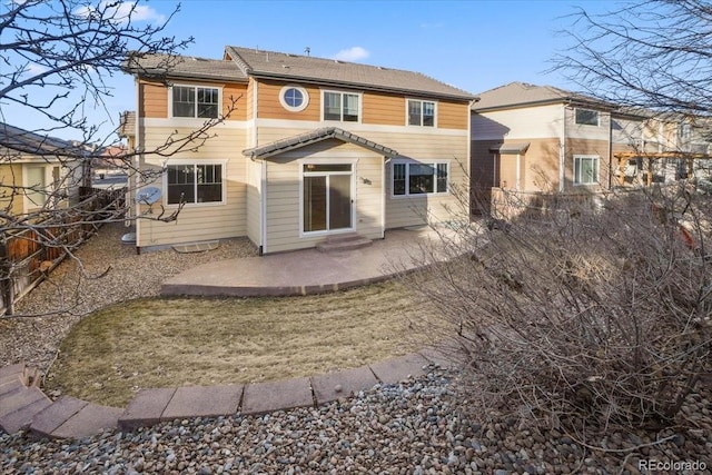 rear view of property featuring a patio area and fence