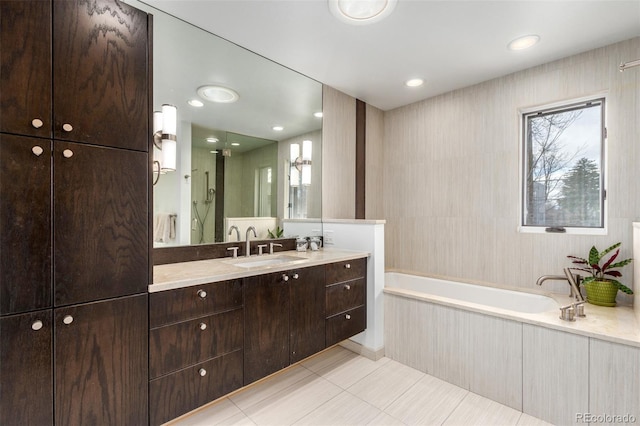 full bath with recessed lighting, tile patterned flooring, a bath, and vanity