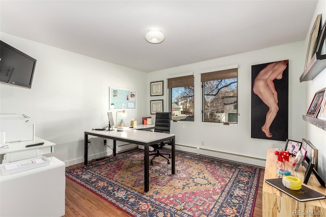 office area featuring a baseboard heating unit, wood finished floors, and baseboards